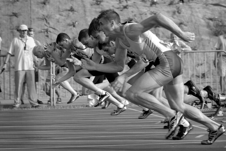 Your First Training Plan for Running – Best Fitness Stores athletes running on track and field oval in grayscale photography